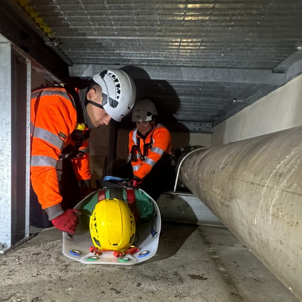 Rescue team working in a confined space to rescue another person.