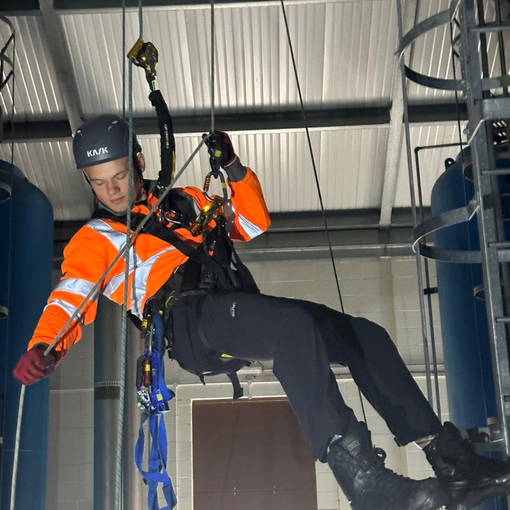 Harry hanging in a rope going down.