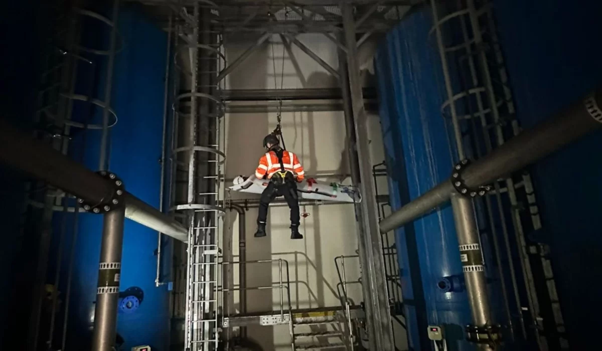 Person performing rescue using a rope from a high altitude.
