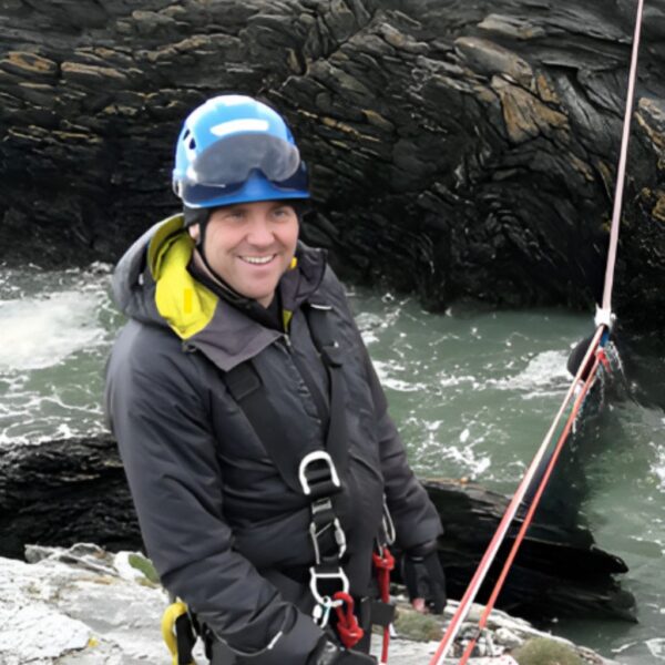Steve standing beside a river ready to do a rescue.