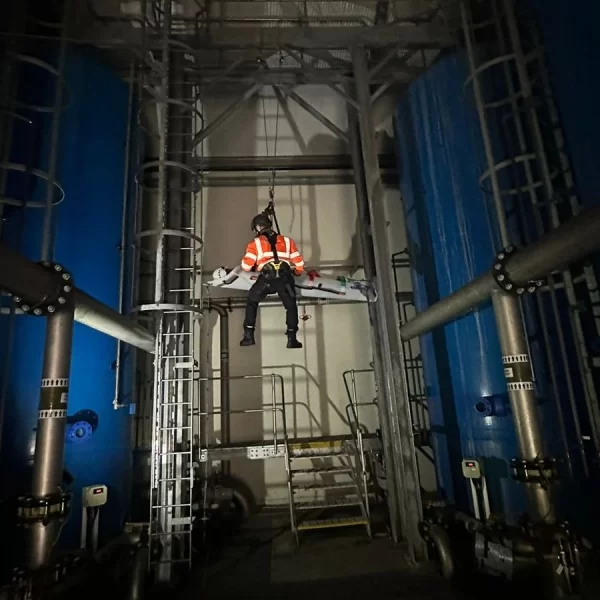 Rescue team hanging through a rope and going up for safety after rescue.