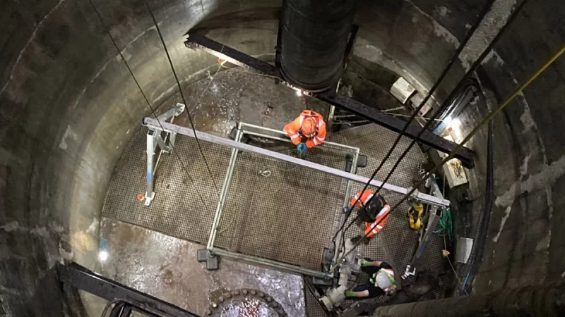 Two rope access experts inside a confined space checking the area