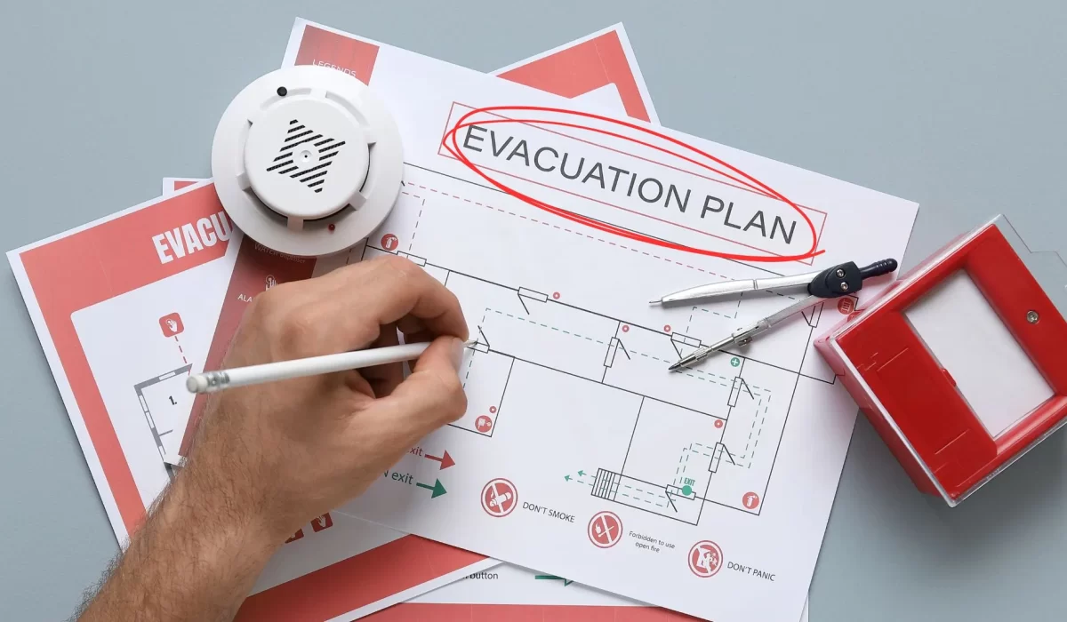 an expert fire safety personnel planning an emergency evacuation solution in a floor plan